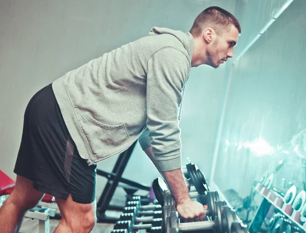 Sportlicher Mann Kapuzenpulli Steht Vor Einem Spiegel Und Nimmt Hanteln — Stockfoto