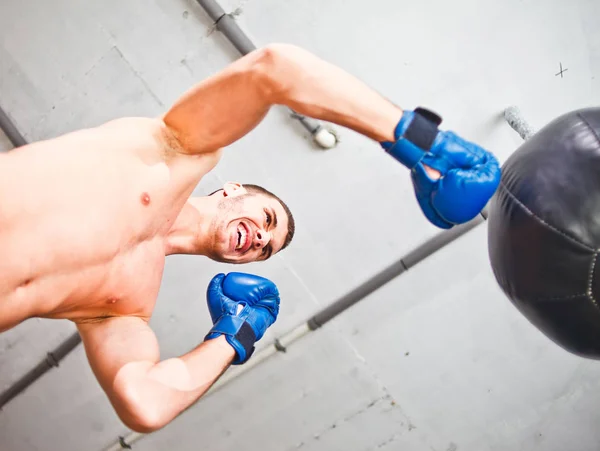 Handsome Sports Man Boxer Trains Hand Punches Punching Bag Bottom — Stock Photo, Image