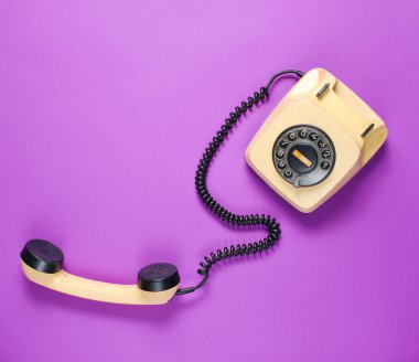 Mor arka plan üzerinde yakışıklı ile Retro döner telefon. Üstte görüntü