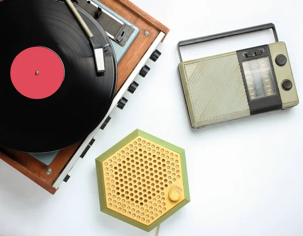 Pop culture retro objects on white background. Vinyl record player, radio receivers. Top view, media, flat lay
