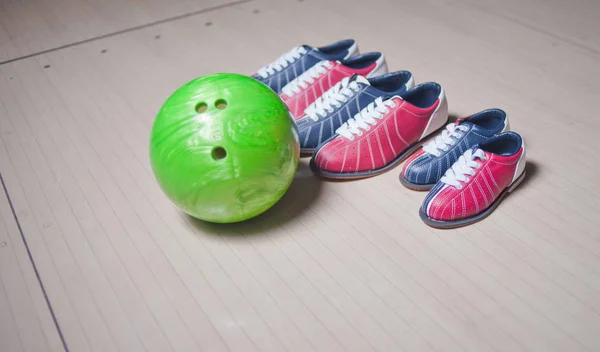 Many Shoes and ball on floor in bowling club. Family sports pastime