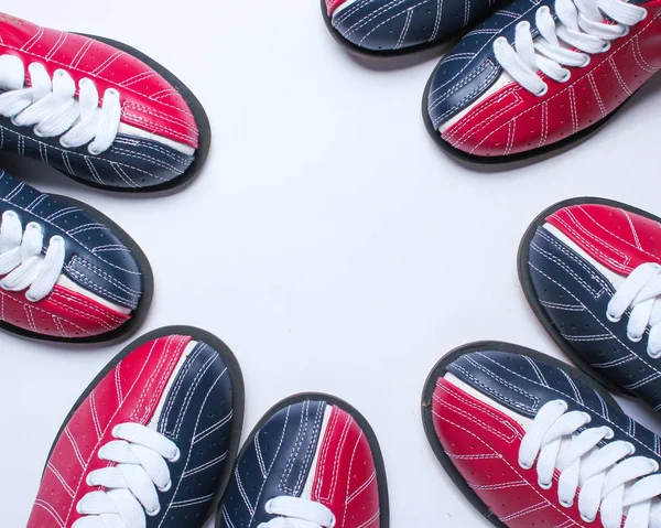 Many bowling shoes on a white background. Entertainment for groups of friends. Copy space. Top view