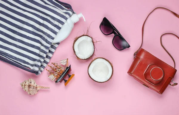 Summer creative background. Beach striped bag, accessories on a pink background. Top view. Flat lay