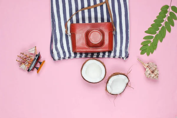 Summer creative background. Beach striped bag, accessories on a pink background. Top view. Flat lay