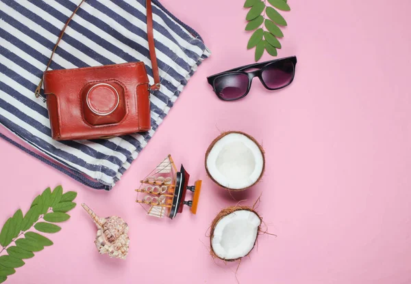 Summer creative background. Beach striped bag, accessories on a pink background. Top view. Flat lay. Copy space
