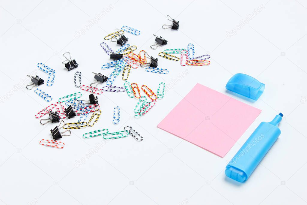 Stationery office supplies. Paper clip, felt-tip pen, memo piece of paper on white background