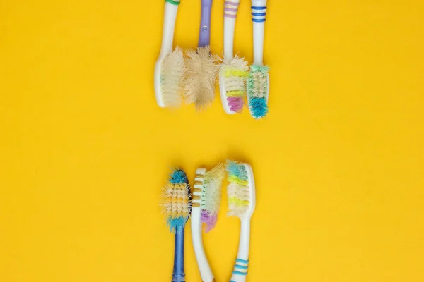 Old Used Toothbrushes Yellow Background Dental Care Concept Top View — Stock Photo, Image