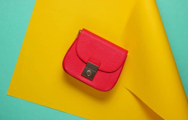 Kağıt kaplamalı kırmızı deri çanta. Pastel renk eğilimi, minimalist güzellik ve moda natürmort hayat. Üst görünüm