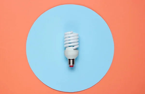 Spiral Eco Light Bulb Colored Paper Background Top View Minimalistic — Stock Photo, Image