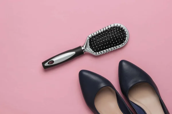 Women's accessories on pink pastel background. Comb, high heel shoes. Minimalistic beauty and fashion concept. Top view
