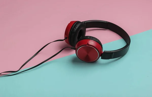 Modern wired headphones on pink blue pastel background. Music lover concept.