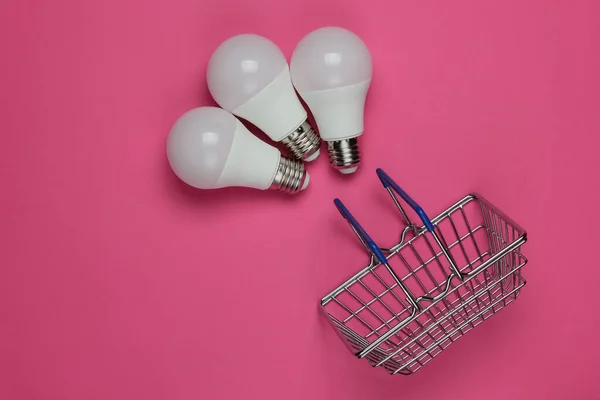 Three Led Light Bulbs Shopping Basket Pink Background Top View — Stock Photo, Image