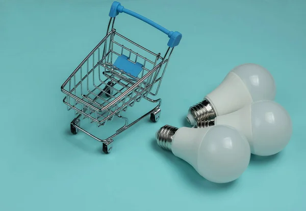 Three Led Light Bulbs Shopping Cart Blue Background — Stock Photo, Image