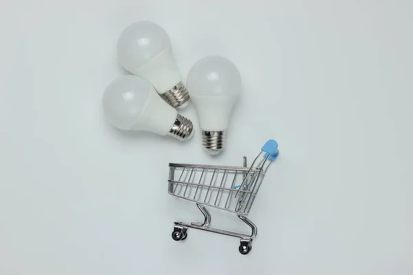 Three Led Light Bulbs Shopping Trolley White Background Top View — Stock Photo, Image