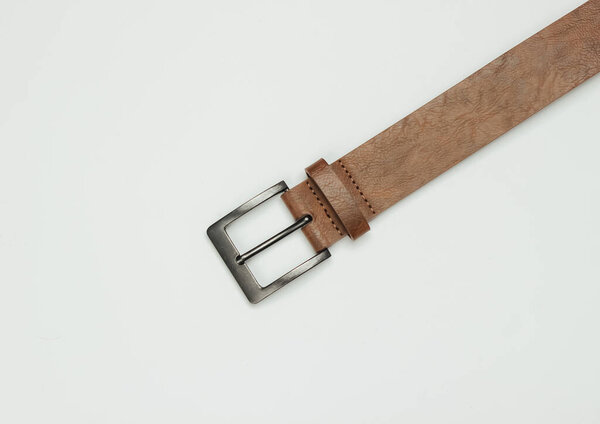 Leather brown belt on a white background