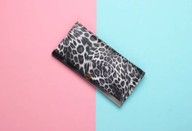 Pembe pastel arka planda şık bir cüzdan. Moda minimalizmi. Üst görünüm
