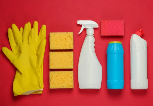 Set of products for cleaning the house on red background. Top view.