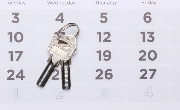 Payment of rent for housing. House keys on the calendar.