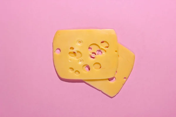 stock image Cheese slices on a pink pastel background. Top view. Minimalism food concept