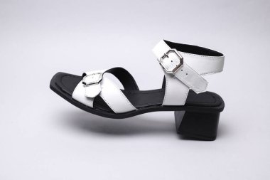 Women's leather sandal floating on white background