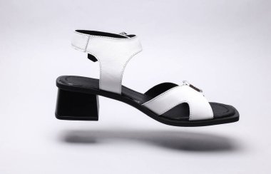 Women's leather sandal floating on white background
