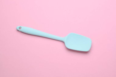 Silicone kitchen spatula on a pink background