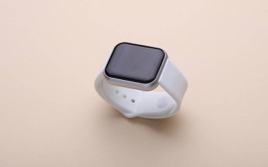 Modern smart watch on beige background