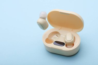 Wireless Earphones with Charging Case on blue Background