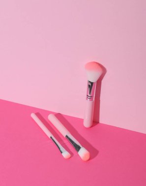 Makeup brushes on pink background. Creative layout. Beauty concept