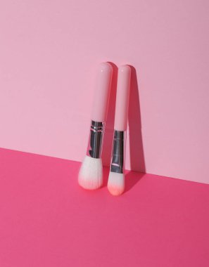 Makeup brushes on pink background. Creative layout. Beauty concept