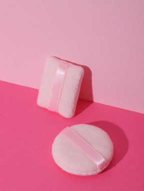 Makeup sponges on pink background. Creative layout