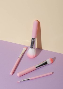 Makeup brushes on pastel background. Creative layout. Beauty concept