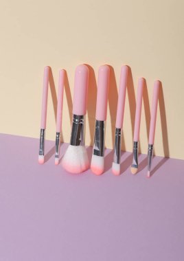 Makeup brushes on pastel background. Creative layout. Beauty concept