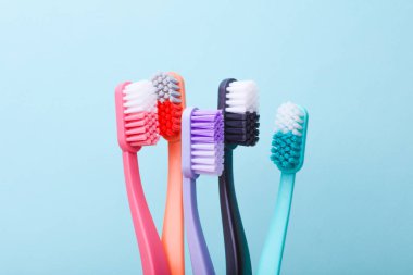 Many Plastic toothbrushes on blue background