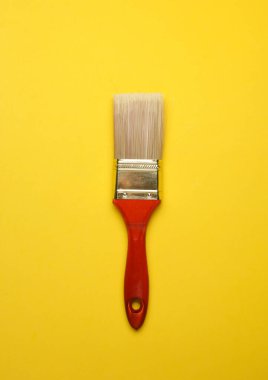 Clean paintbrush on yellow background. Top view