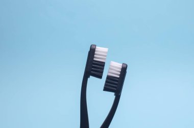 Mavi arka planda siyah plastik diş fırçaları. Diş bakımı