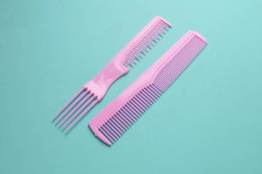 Nane yeşili arkaplanda pembe plastik taraklar.