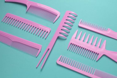 Nane yeşili arkaplanda pembe plastik taraklar.