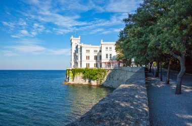 Trieste, Italy - August 10, 2010: View of the Miramare castle on the seafront clipart