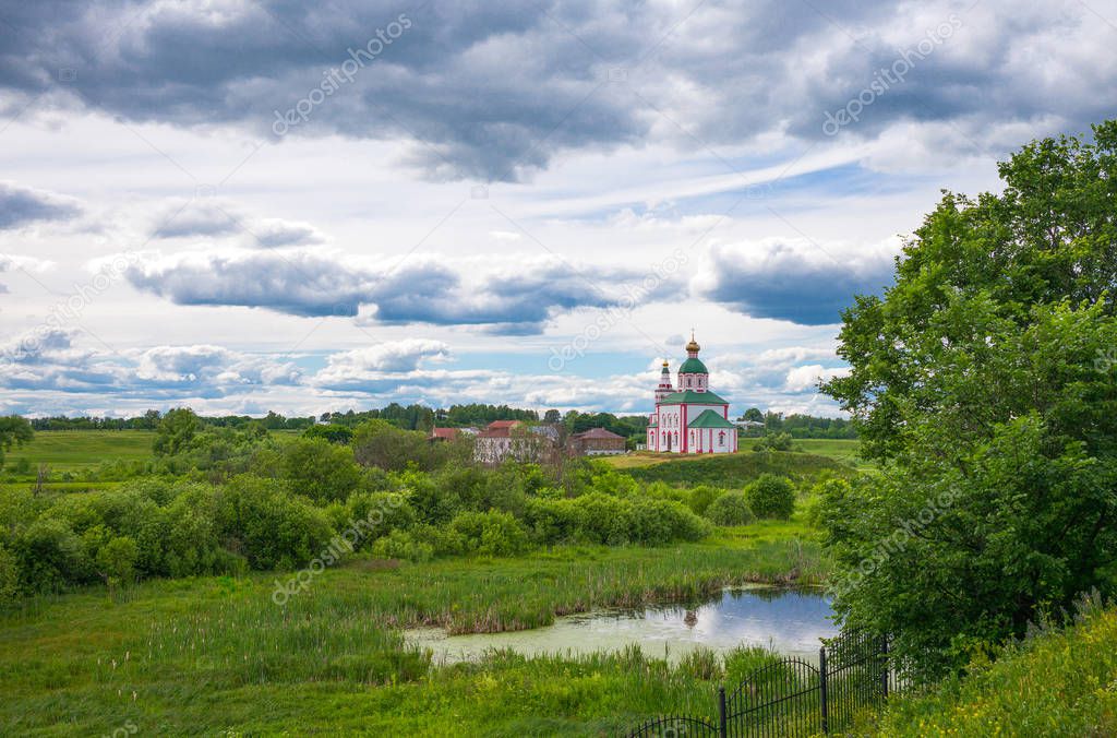 Russia, Suzdal, landscape of the valley with a church seen from yhe village