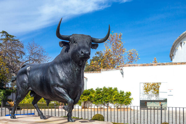 Ronda,  Spain - December 11, 2014: A bull monument in front of Plaza de Toros (Bullring)