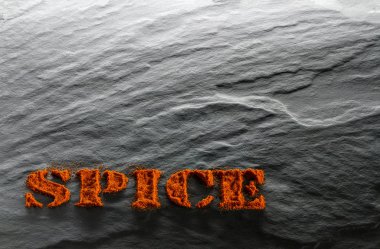 Baharat. Siyah bir dokusal arka plan arka ışık içinde zemin kırmızı biber