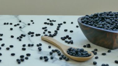 ahşap kase ve kaşık siyah fasulye