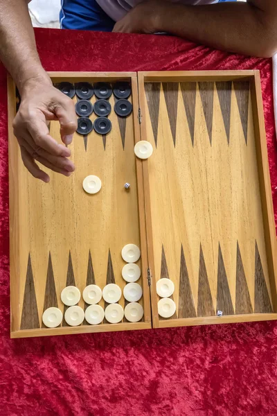 man throws dice while playing tabla. Top view