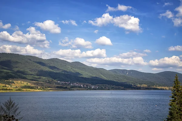 Relaxing mountain landscape at lake with calm water and beauty sky, Dospat, Bulgaria