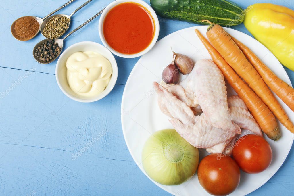 Dietary chicken meat and fresh vegetables for rural cuisine. Ingredients for healthy dish on wooden table. Top view. Copy space.