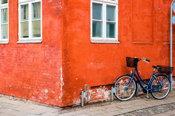 Exterior architecture. Bicycles in front of orange facace in Helsingor, Denmark.