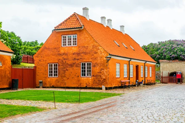 Typical old orange scandinavian house with brick walls and white windows in Denmark