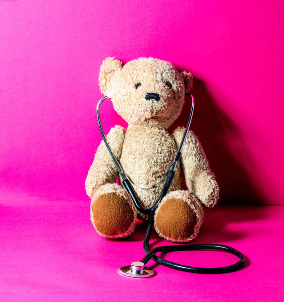 Portrait of teddy bear with stethoscope for playing doctor