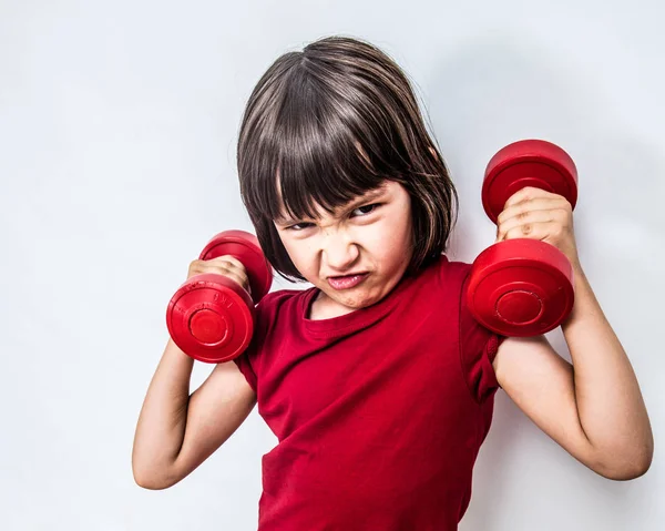 Mad frowning child expressing rage and violence with bully dumbbells — Stock Photo, Image